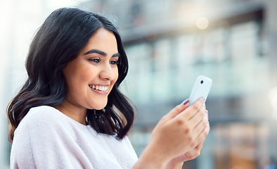 Image showing Connect with more contacts, collect more opportunities. a young businesswoman using a smartphone against an urban background.