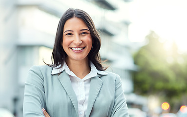 Image showing Success starts with how you dress. Portrait of a confident young businesswoman standing against an urban background.