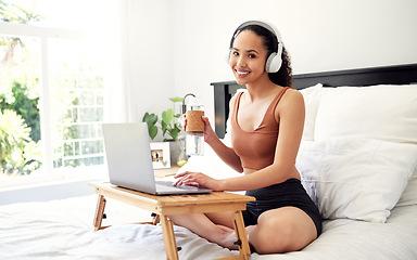 Image showing Today is a chance to create the life you want. a young woman using a laptop while sitting on her bed at home.