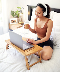 Image showing This is my time. a young woman using a laptop while sitting on her bed at home.