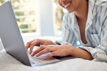 Image showing Inspiration finally hit me. an unrecognizable person using a laptop while relaxing on her bed at home.