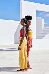 Image showing Brightening up your summer. Full length shot of two attractive young women posing on a rooftop outdoors.