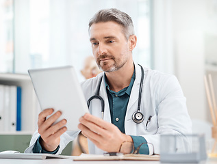 Image showing Health and medical research has high value to society. a mature doctor working on a digital tablet in a medical office.