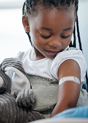 Image showing Immunisations can save your childs life. an adorable little girl with a plaster on her arm after an injection.