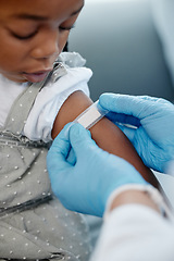 Image showing Getting her routine childhood vaccination. Closeup shot of an unrecognisable doctor applying a plaster to a little girls arm after an injection.