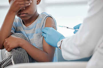 Image showing Itll be over soon and then youll feel better. a little boy looking scared while getting an injection on his arm from a doctor.