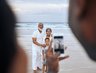 Image showing Did you get it. an unrecognizable man taking a picture of a mature couple and their grandson at the beach.