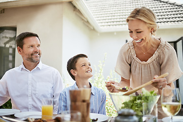 Image showing Mom always make sure that everyone one is fed. a family enjoying a meal together.