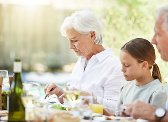 Image showing The only time when everyone is quiet...a family enjoying a meal together at home.