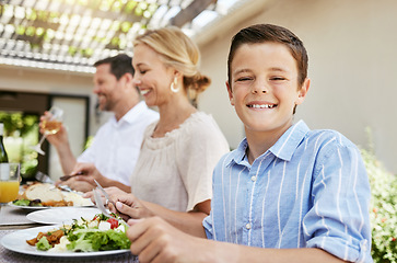 Image showing Im excited to dig in. a young boy enjoying a meal with her family at home.