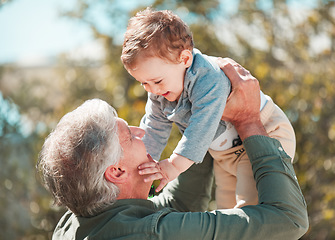 Image showing Whos my special boy. a handsome mature man and his grandson outdoors.