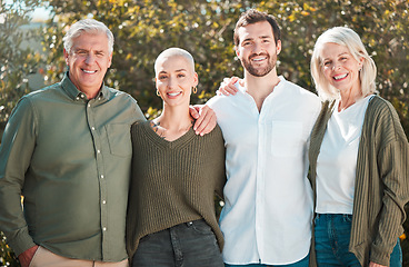 Image showing Family moments. Cropped portrait of an attractive young woman standing outside with her husband and parents.