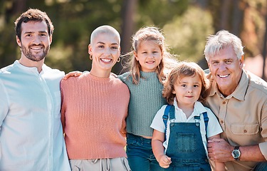 Image showing Say cheese for the family portrait. a multi-generational family posing together outdoors.