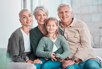 Image showing A beautiful young woman and her daughter visiting the grandparents. An adorable little girl and her mother sitting on the sofa with her grandfather and grandmother. A happy family bonding at home