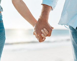 Image showing Together is my favourite word. a mature couple holding hands on the beach.