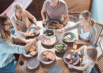 Image showing Would you like some. High angle shot of a family sitting together and enjoying lunch.