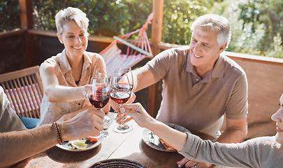 Image showing Cheers to family. a senior couple sitting with their family and toasting with wine during lunch.