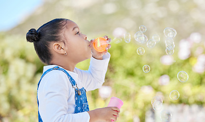 Image showing A wish sent with every bubble. a little girl blowing bubbles outside.