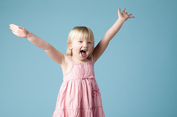 Image showing Her excitement fills the room. an excited little girl against a studio background.