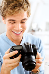 Image showing These are perfect. a young man using his digital camera at home.