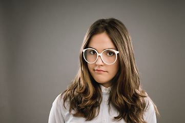 Image showing When in doubt. a young woman wearing retro glasses against a studio background.