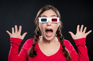 Image showing What a scare that was. a young woman wearing 3D glasses against a studio background.