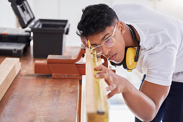 Image showing A good carpenter never disappoints. a carpenter doing measurements on wood.