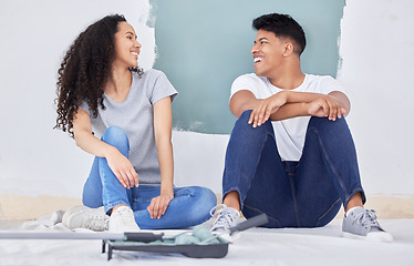 Image showing Were always ready for a challenge. a young couple painting a wall in a room together.