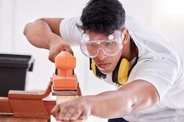 Image showing Im almost done with this project. a carpenter sanding a wood project.