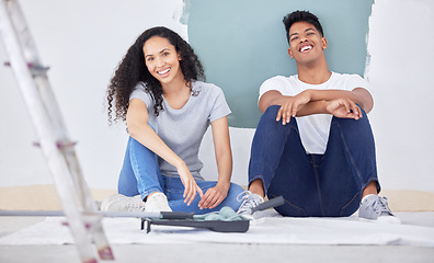 Image showing We decided to paint the house ourself. a young couple painting a wall in a room together.