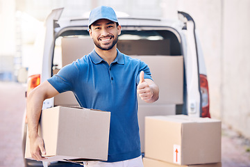 Image showing To give real service you must add something. Portrait of a young delivery man showing thumbs up while holding a box.