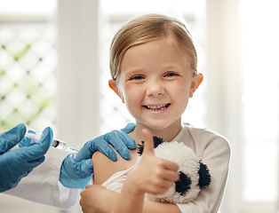 Image showing Visiting the doctor can be fun. a doctor giving a little girl an injection during a checkup at home.