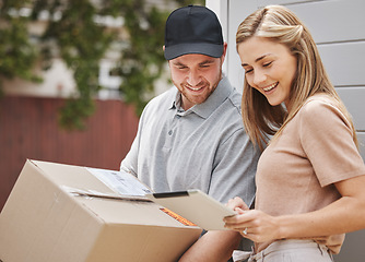 Image showing Its a more convenient way to sign for items. an attractive young woman using a tablet to sign for her delivery.