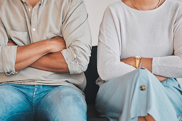 Image showing Im not going to put up with you anymore. Closeup shot of an unrecognisable couple sitting with their arms crossed during an argument at home.