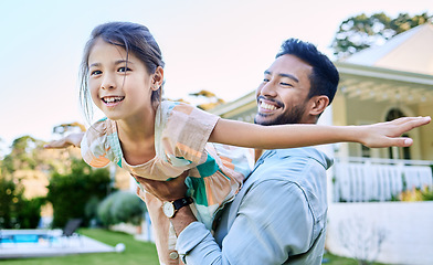 Image showing Dad always encourages me to do whatever i want. a young father holding up his daughter in the garden outside.