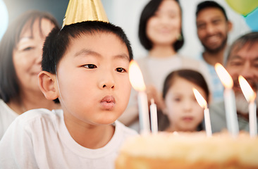 Image showing A birth-date is a reminder to celebrate. an adorable little boy celebrating a birthday with his family at home.