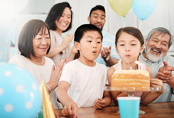 Image showing Celebrate and look forward to the coming year. an adorable little boy and girl celebrating a birthday with their family at home.