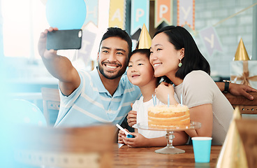 Image showing Cherish all your happy moments. a happy family taking selfies while celebrating a birthday at home.