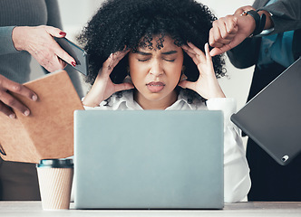 Image showing Youre giving me a headache. an attractive young businesswoman sitting in the office and feeling stressed while her colleagues put pressure on her.