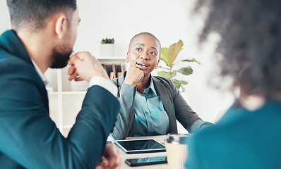 Image showing Im listening. an attractive young businesswoman sitting and having a meeting with her colleagues in the office.