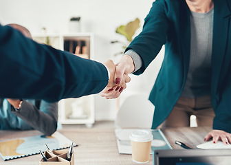 Image showing Youve got yourself a deal. two unrecognisable businesspeople shaking hands during a meeting in the office.