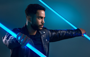 Image showing The future of fashion. Conceptual shot of a stylish young man posing in studio against a blue background.