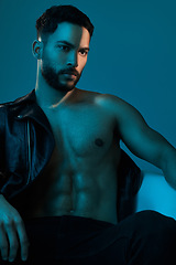 Image showing Making style look sexy. Conceptual shot of a stylish young man posing in studio against a blue background.