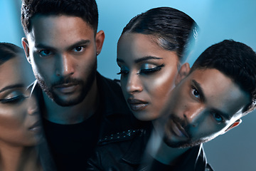 Image showing Youll find them in your favourite magazine. Conceptual portrait of a stylish young man and woman posing in studio against a blue background.