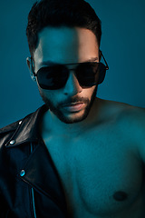 Image showing Whats cooler than confidence. Conceptual shot of a stylish young man posing in studio against a blue background.