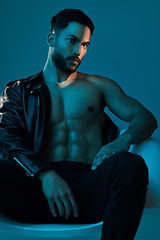 Image showing A little leather for the ladies. Conceptual shot of a stylish young man posing in studio against a blue background.