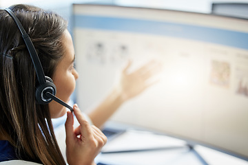 Image showing Let me tell you about what we do. a call center agent looking at something on her desktop.