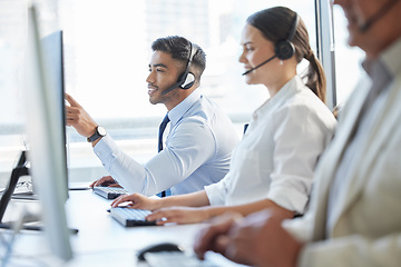 Image showing Theyll help you in a matter of minutes. call center agents wearing headsets while sitting at their computers.