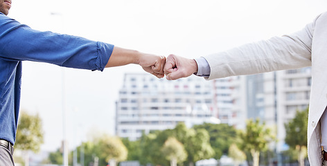 Image showing Great things in business are never done by one person. two unrecognizable business people fist bumping outside.