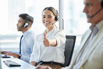 Image showing Thank you for calling. a young woman showing thumbs up while working in a call center.